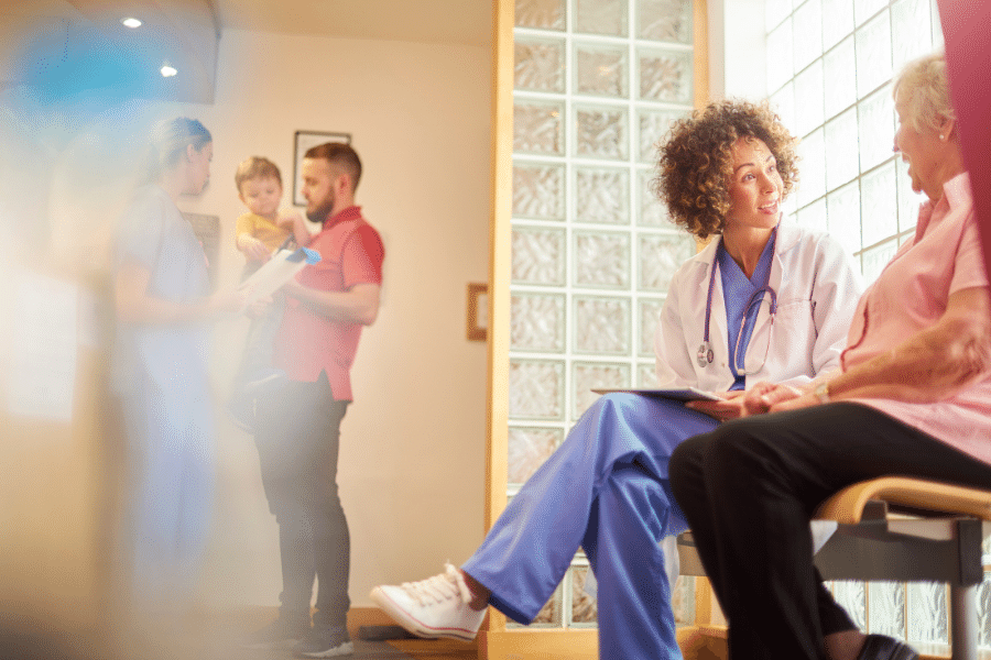 Doctor talking to a patient in a clinic lobby waiting room area.