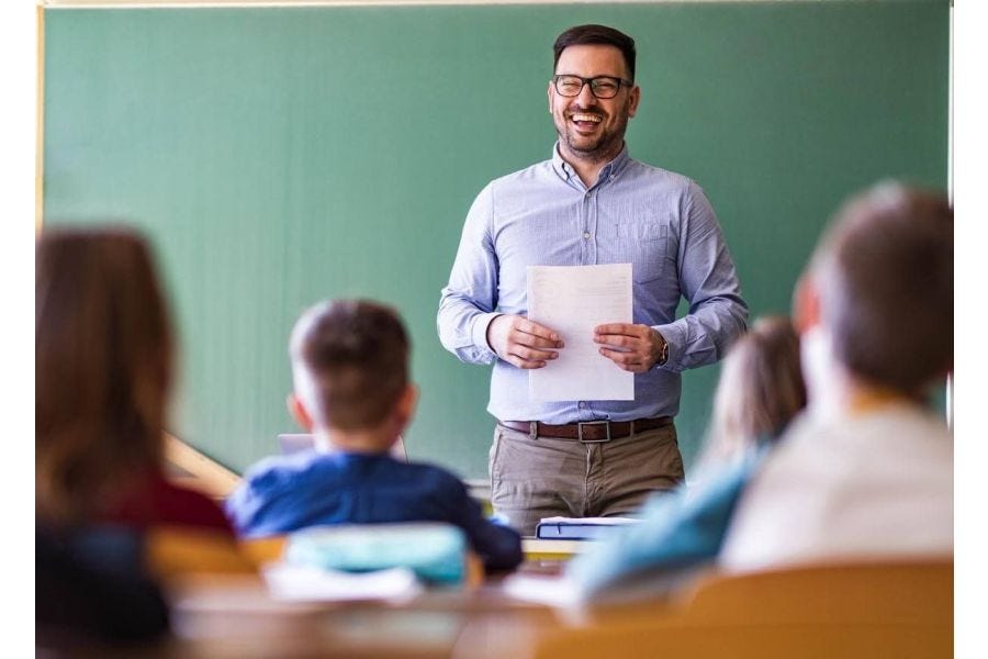 Teacher teaching in front of a class.