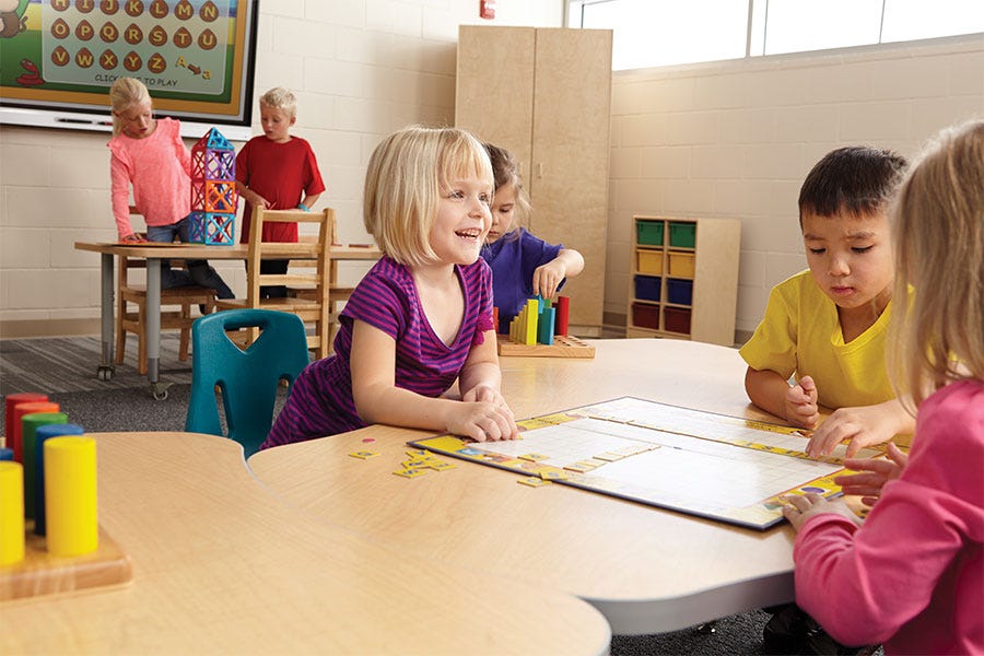 Worthington Direct Young children working together at a curved collaborative table in a classroom.