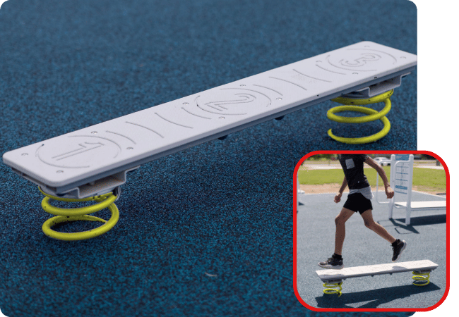 Worthington Direct Pre-teen balancing on a balance beam outdoors on a school playground.