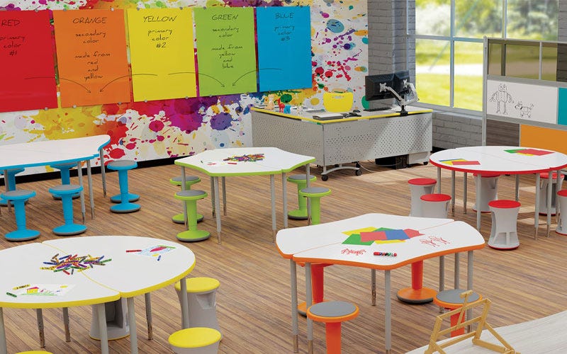 Dry erase student desks and glass board surfaces in a school classroom