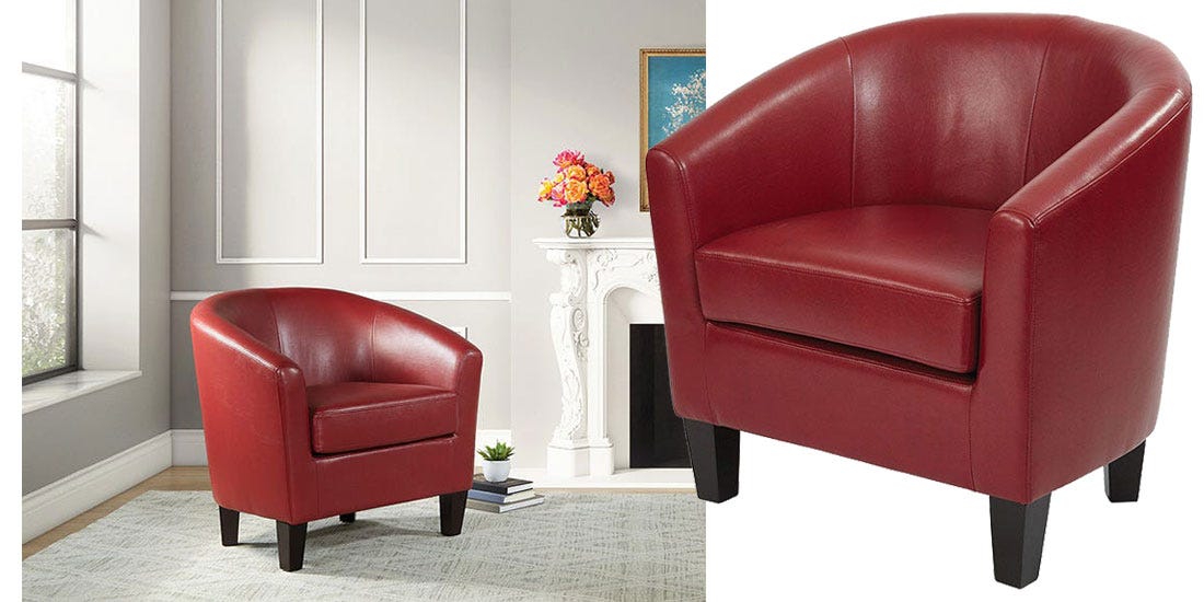 A vibrant red club chair positioned in an elegant living room beside a cozy fireplace.