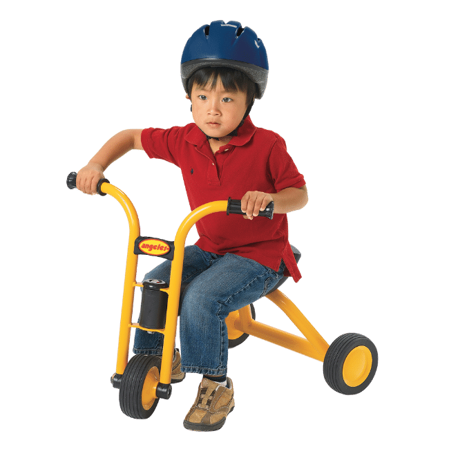 Preschool child riding a mini pusher tricycle while wearing a safety helmet. 